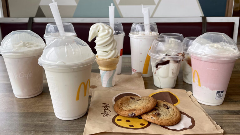 The image shows the mcdonalds milkshake on the table and the refltects are mcdonalds milkshakes Gluten Free