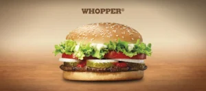 A juicy Burger King Whopper, featuring a sesame seed bun, a flame-grilled beef patty, lettuce, tomato, onion, pickles, and ketchup. (Burger King Whopper Calories)