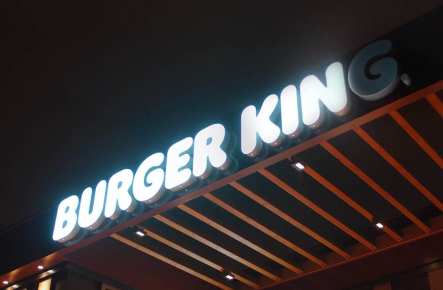 A brightly lit Burger King sign at night, with the letters "BURGER KING" in white against a dark background.Is Burger King open on Labor Day