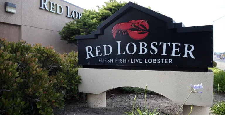 A red lobster sign featuring a lobster logo, with the text "RED LOBSTER" and "FRESH FISH LIVE LOBSTER" below. This image likely represents a Red Lobster restaurant, where you can find a menu with prices for various seafood dishes. Lets find out Red Lobster menu with prices