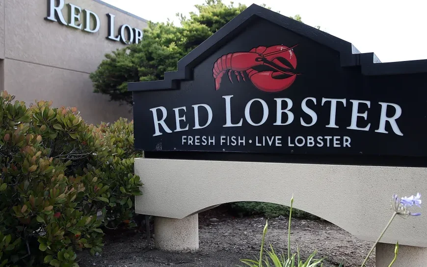 A red lobster sign featuring a lobster logo, with the text "RED LOBSTER" and "FRESH FISH LIVE LOBSTER" below. This image likely represents a Red Lobster restaurant, where you can find a menu with prices for various seafood dishes. Lets find out Red Lobster menu with prices