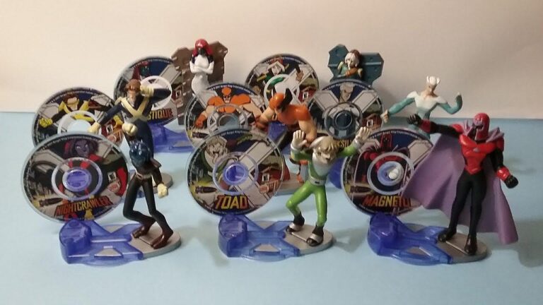 A collection of X-Men Burger king 90s toys Evolution action figures. The figures are standing on circular bases and are holding discs with images of the characters. The characters included are Cyclops, Jean Grey, Beast, Wolverine, Nightcrawler, Storm, Toad, and Magneto.