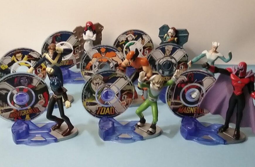 A collection of X-Men Burger king 90s toys Evolution action figures. The figures are standing on circular bases and are holding discs with images of the characters. The characters included are Cyclops, Jean Grey, Beast, Wolverine, Nightcrawler, Storm, Toad, and Magneto.