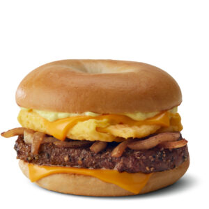 A McDonald's Breakfast steak Bagel recipe with a beef patty, scrambled eggs, cheese, and onions on a toasted bagel.