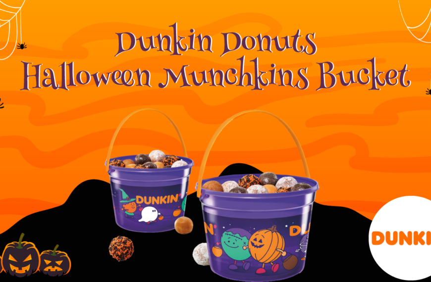 Dunkin' Donuts Halloween Munchkins Bucket. Two purple buckets filled with bite-sized donuts are on display against an orange background with Halloween decorations. The buckets have a Dunkin' Donuts logo and are adorned with Halloween-themed graphics.